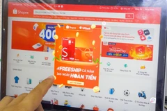 A customer shops online. In Vietnam, the e-commerce landscape is dominated by three major platforms. (Photo: VNA)